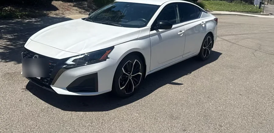 White Nissan Altima SR sedan with black alloy wheels